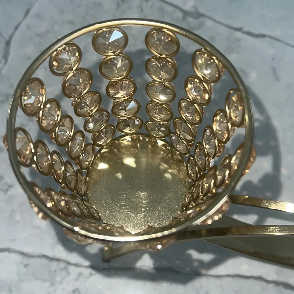 Elegant gold metal like candle holder with beautiful shiny crystal like gems